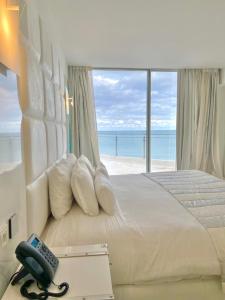 a bedroom with a bed with a view of the ocean at La Tour Blanche in Gammarth