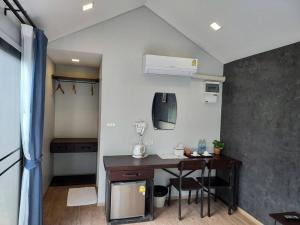 a room with a desk and a room with a bedroom at The Sept Korat in Nakhon Ratchasima