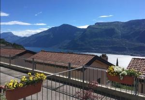a balcony with flower pots and a view of mountains at Appartamento Flora in Tremosine Sul Garda