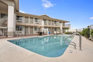 a swimming pool in front of a building at Days Inn by Wyndham Globe in Globe