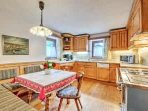 a kitchen with a table with a vase of flowers on it at Welcoming Holiday Home with Garden in Tyrol in Matrei in Osttirol