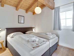 A bed or beds in a room at Modern Chalet in Mühlbach am Hochkönig near Ski Area