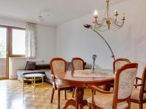 a living room with a table and chairs and a couch at Blissful Apartment in Ulrichsberg with a view in Ulrichsberg