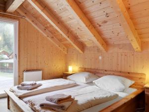 a bedroom with two beds in a wooden house at Chalet in Stadl an der Mur near the ski area in Stadl an der Mur