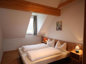 A bed or beds in a room at Apartment St Margarethen near Ski Lift