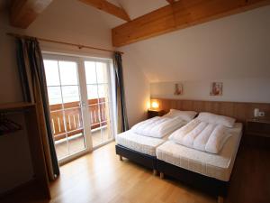 a bedroom with a bed and a large window at Modern Apartment in Sankt Margarethen near Ski Area in Sankt Margarethen im Lungau