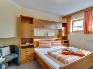 フィスにあるLively flat near a ski resort in Fissの小さなベッドルーム(ベッド1台、椅子付)