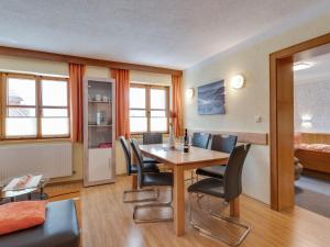 a dining room with a table and chairs at Lively flat near a ski resort in Fiss in Fiss