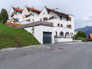 a white house on a hill with a driveway at Lively flat near a ski resort in Fiss in Fiss