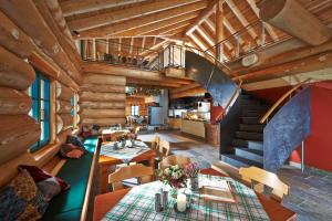a dining room with a staircase in a log house at Hotel Therme Bad Teinach in Bad Teinach-Zavelstein