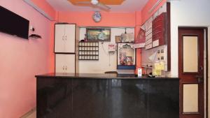 a bar in a room with red walls at Hotel Mohan by WB INN in Agra
