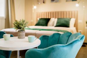 a living room with blue chairs and a couch at Oisife Apartments in Cagliari