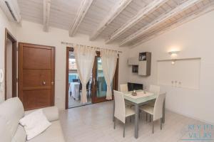 uma cozinha e sala de jantar com mesa e cadeiras em Brigata House - Luxury 2 beds, wifi, balcony,sea view - Key to Villas em Castelsardo