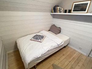 a small bed in a corner of a room at 8 person holiday home in MÅLØY-By Traum in Måløy