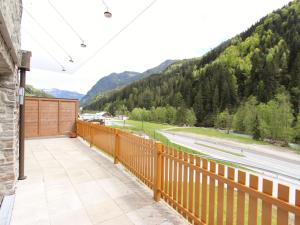 a balcony with a view of a road and mountains at Modern apartment near Saalbach Hinterglemm in Viehhofen