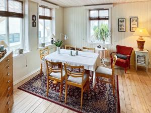 a kitchen and dining room with a table and chairs at 8 person holiday home in MÅLØY-By Traum in Måløy
