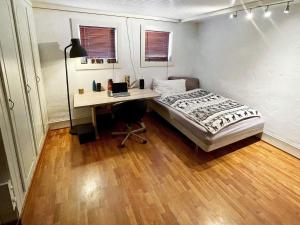 a bedroom with a bed and a desk with a laptop at 8 person holiday home in MÅLØY-By Traum in Måløy