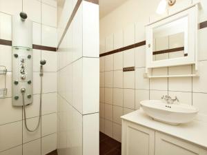 a bathroom with a sink and a shower at Apartment with terrace in Salzburg in Lungötz