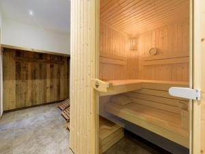 a sauna with wood paneling and a wooden wall at Apartment in St Johann im Pongau with sauna in Alpendorf