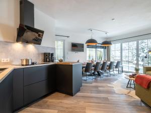 a kitchen with black cabinets and a dining room at Apartment in St Johann im Pongau with sauna in Alpendorf