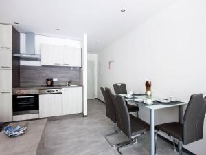 a kitchen and dining room with a table and chairs at Apartment Bergblick Anna in Kaprun with balcony in Kaprun