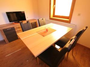 a conference room with a wooden table and chairs at Charming Apartment in Mittersill near Ski Area in Mittersill