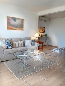 a living room with a couch and a table at Panoramic views to the sea in Malaga in Málaga