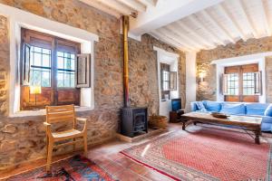a living room with a blue couch and a wood stove at Finca Arroyo de las Adelfas in Málaga