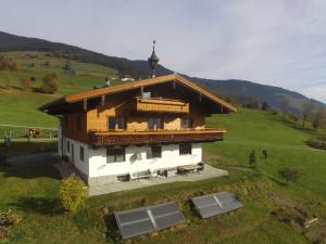 a small house in a green field with a hill at Luxurious Apartment in Mittersill with Balcony in Mittersill