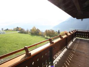a balcony with a view of a field and mountains at Luxurious Apartment in Mittersill with Balcony in Mittersill