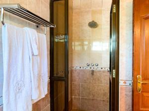 a bathroom with a shower with white towels at Oilepo Cottage in Naivasha +42 photos