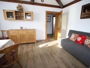 a living room with a couch and a table at Snug Holiday Home in Sankt Johann im Pongau with Garden in Wagrain