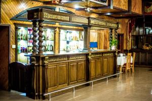 a large wooden bar in a room with a table at Приозерний заїзд in Rulevo