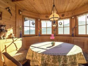 a dining room with a table and some windows at Chalet in ski area in Piesendorf in Piesendorf
