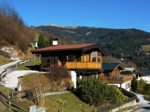 a house with a balcony on a hill at Chalet in ski area in Piesendorf in Piesendorf
