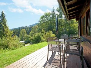 a table and chairs sitting on a deck with a view at Quaint Chalet in W rgl Boden with Terrace in Bad Häring