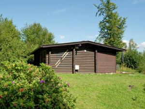 eine kleine Holzhütte auf einem Grasfeld in der Unterkunft Quaint Chalet in W rgl Boden with Terrace in Bad Häring