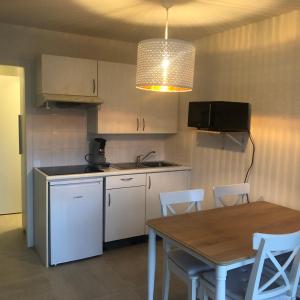 a kitchen with a wooden table and a table and chairs at ANGEL in Bredene