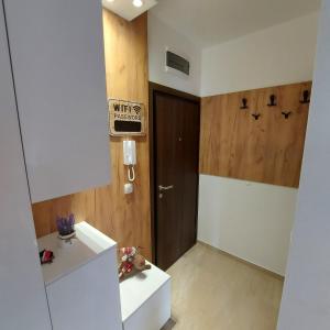 a bathroom with a white counter and a door at Apartman Irvas Zlatibor in Zlatibor