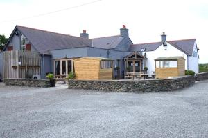 a house with a table and a stone driveway at Blas Mwy Black Lion B and B in Holyhead