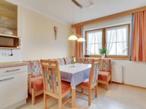 a kitchen and dining room with a table and chairs at Quaint Apartment in Hainzenberg near Horbergbahn in Hainzenberg