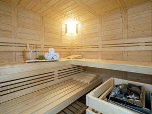 a sauna with wood paneling and a bench in it at Chalet in Muehlbach am Hochkoenig with sauna in Mühlbach am Hochkönig