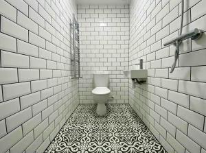 a bathroom with a toilet and a tiled floor at Flat 8, 10 St Johns in Bournemouth