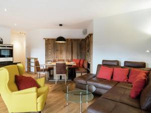 a living room with a couch and a table at Luxury Apartment in Salzburg with terrace in Alpendorf