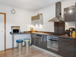 a kitchen with stainless steel appliances and a counter top at Stylish holiday apartment in Leogang Salzburgerland with terrace in Leogang