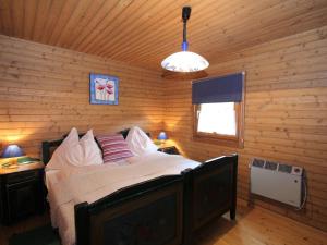 a bedroom with a bed in a log cabin at Modern holiday apartment in a restored farmhouse in Fresach Carinthia in Fresach