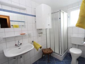 a bathroom with a sink and a toilet and a shower at Modern holiday apartment in a restored farmhouse in Fresach Carinthia in Fresach