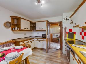 a kitchen with a table with a red table cloth at Apartment near the Koralpe ski area 