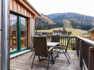 a table and chairs on a balcony with a view at Chalet in Hohentauern in the ski area in Hohentauern