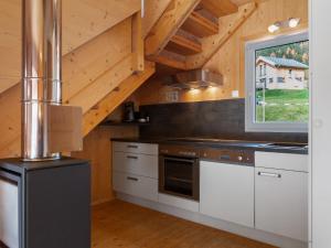 a kitchen with white cabinets and a window at Chalet in Hohentauern in the ski area in Hohentauern